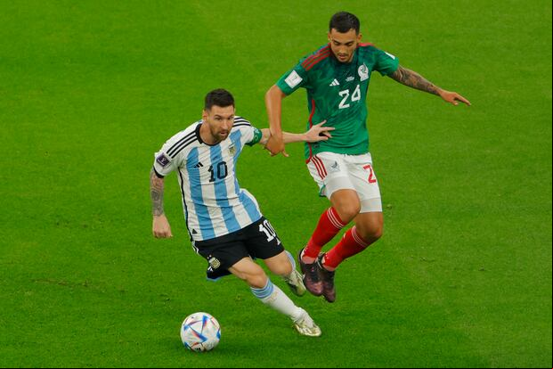 Argentina's forward #10 Lionel Messi (L) fights for the ball with Mexico's midfielder #24 Luis Chavez (R) during the Qatar 2022 World Cup Group C football match between Argentina and Mexico at the Lusail Stadium in Lusail, north of Doha on November 26, 2022. (Photo by Odd ANDERSEN / AFP)